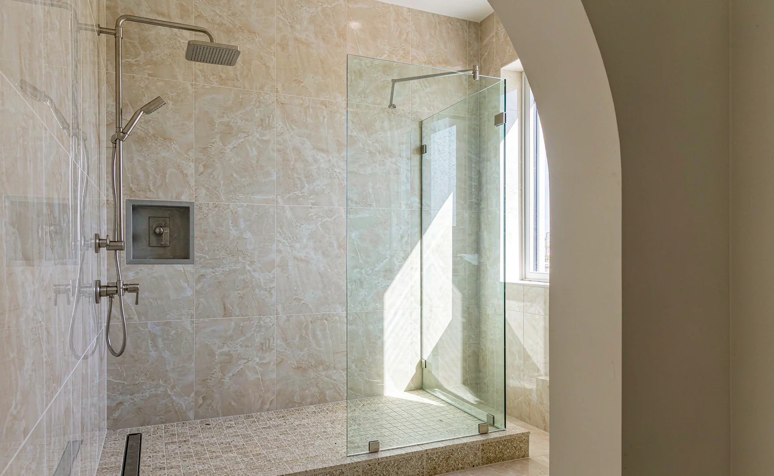 Walk-in shower with anti-slip stone floor, linear drain and glass screen